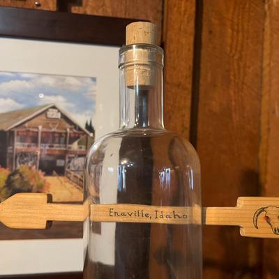 Empty bottle with a wooden arrow sign.