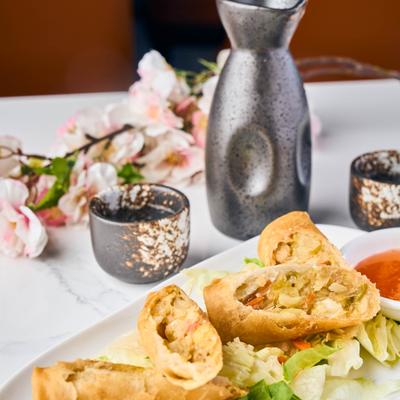 Vegetable spring rolls served over shredded lettuce with sweet dipping sauce.