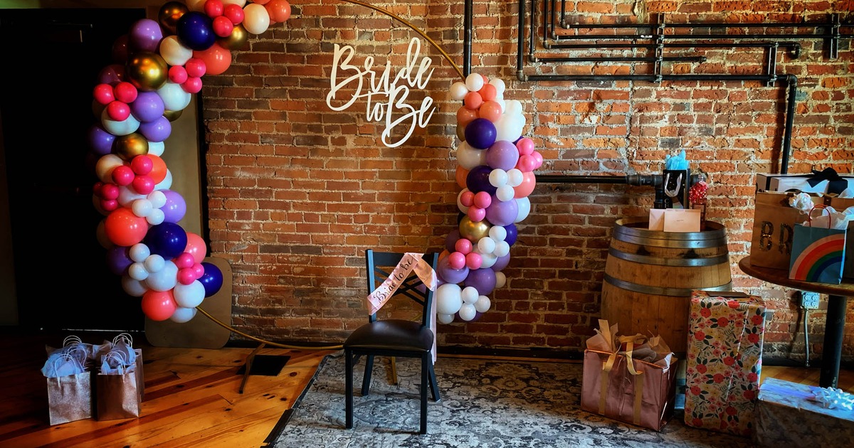 Rustic dining area, tall wooden chairs, wine barrel tables, and a countertop with high chairs