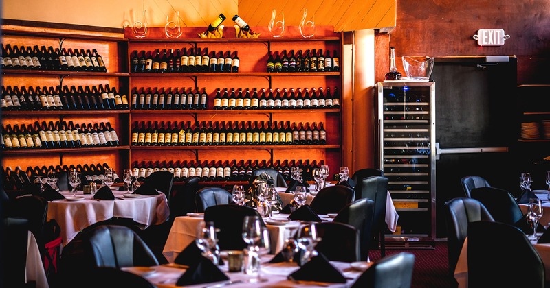 Interior, room with set dining tables and wine shelves