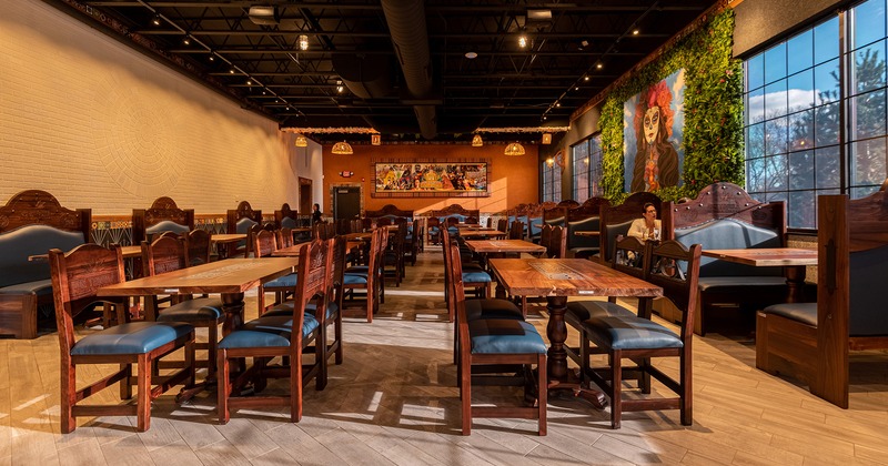 Interior, cozy dining area with a lot of dining tables ready for guests