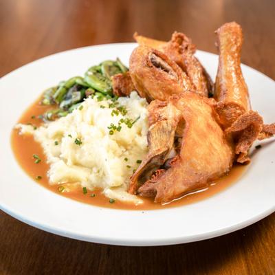 Half roasted chicken with side mashed potatoes.