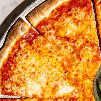 Pizza with cheese, tomato sauce, and basil.