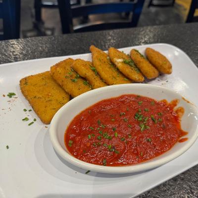 Mozzarella sticks with a side of marinara sauce.