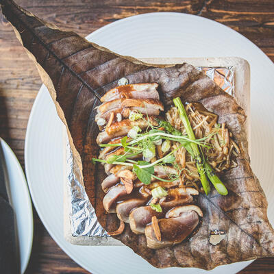 Sliced grilled fish with sauce and decorations