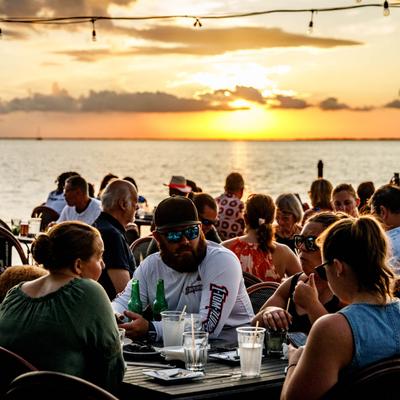Guests eating and drinking outdoors.
