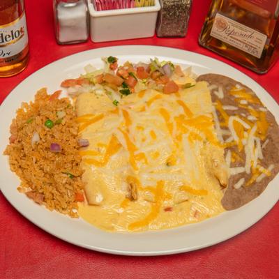 Cheese enchiladas served alongside Mexican rice, refried beans, and pico de gallo.