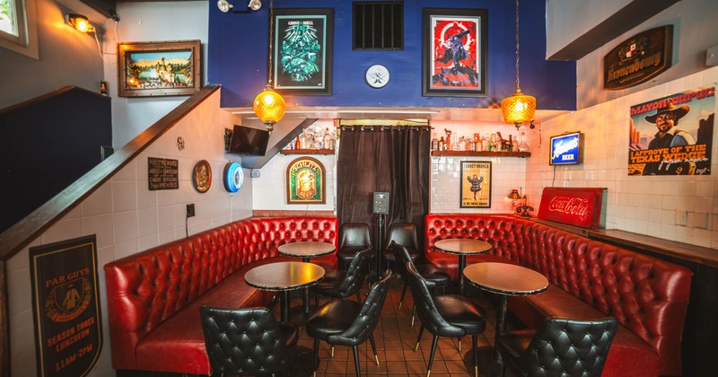 Interior, tables, black leather chairs and red leather seating booths