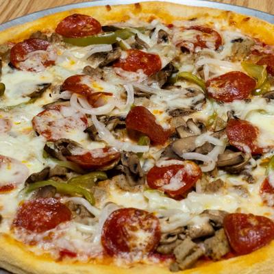 Supreme Pizza topped with pepperoni, sausage, mushrooms, onions, and green peppers.