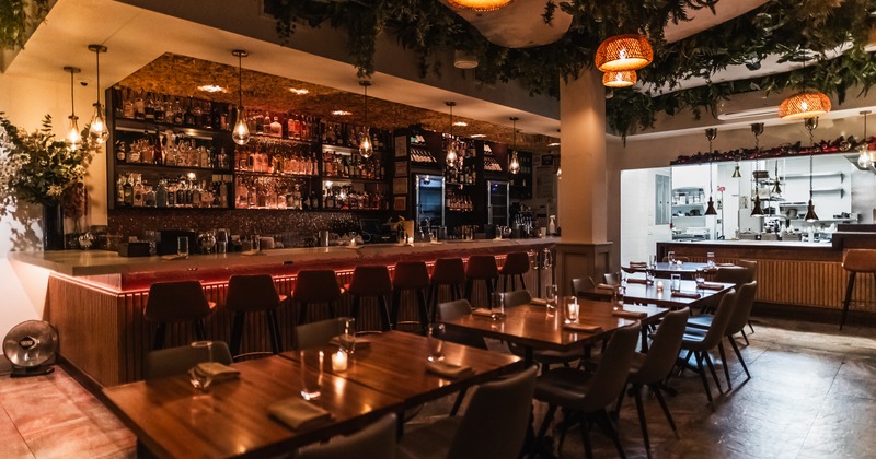 Interior, diner area, tables, chairs, bar behind