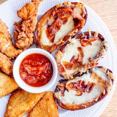 Brothers Sampler with chicken tenders, fried mozzarella, potato skins and a dip.