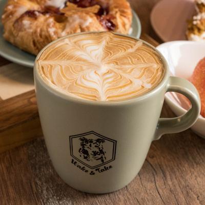 A served latte and food.