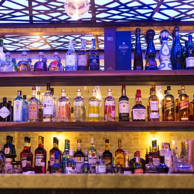 Bottles of liquor lined up on bar shelves