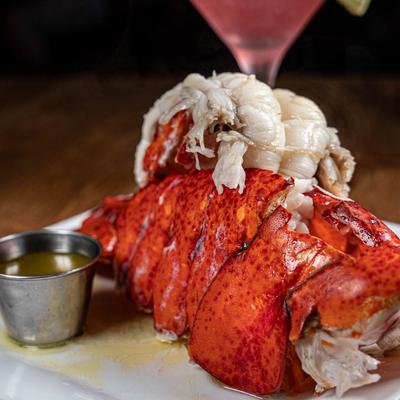 Lobster with melted butter on the side, close up.