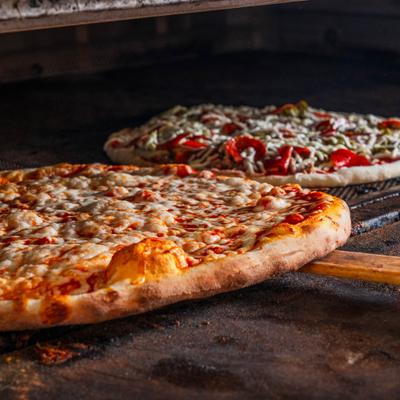 Two pizzas in the pizza oven.