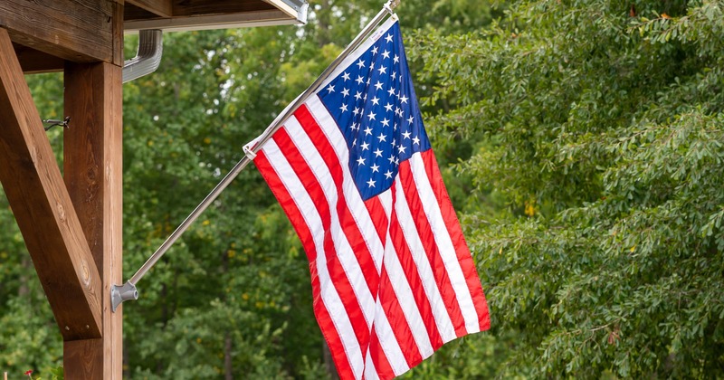 Flag of the USA fluttering on a pole outside