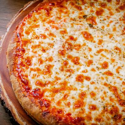 Nine inch cheese pizza, close up.