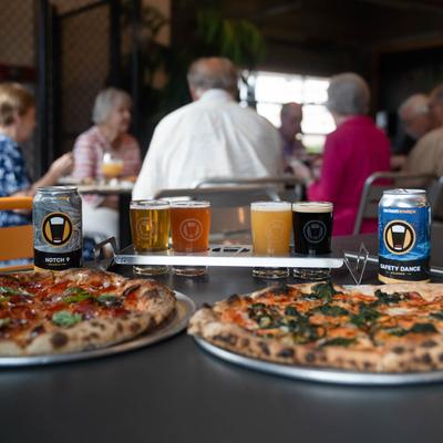 Assorted pizzas and beers.