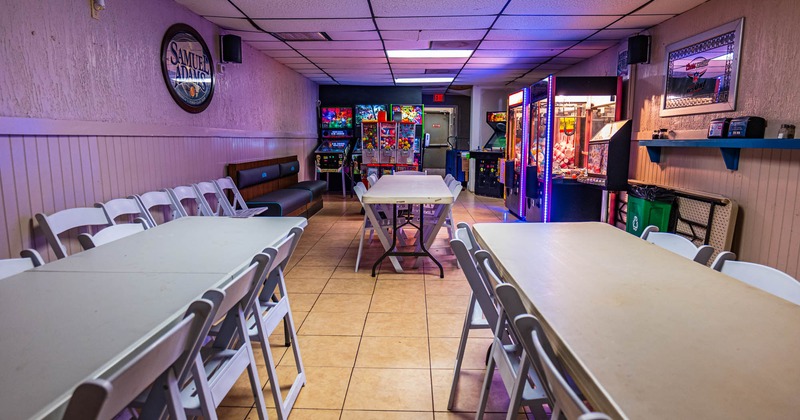 Tables ready for guests, game machines in the back