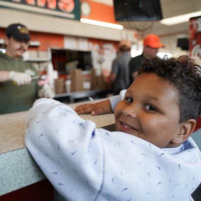 big smile waiting on ice cream cones.