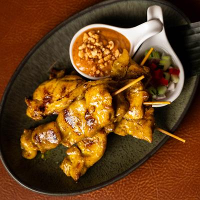 Grilled chicken skewers served with peanut dipping sauce and tangy cucumber relish.