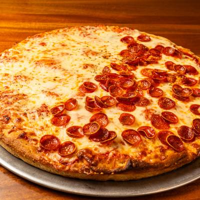 Half-cheese, half-pepperoni pizza on a metal tray.