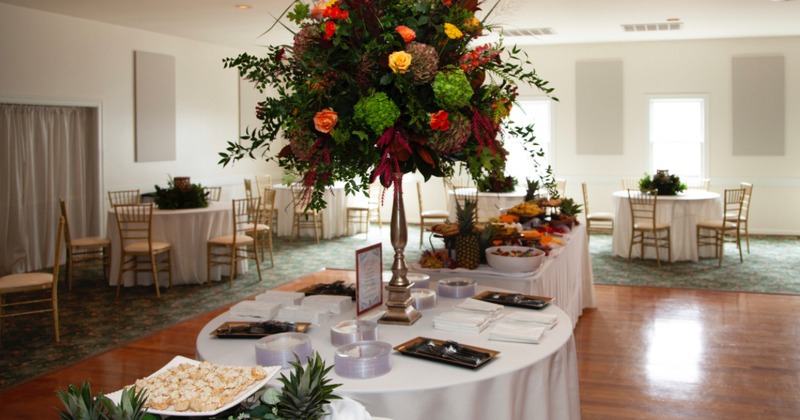 Banquet room, with a large table adorned with an array of food and flowers