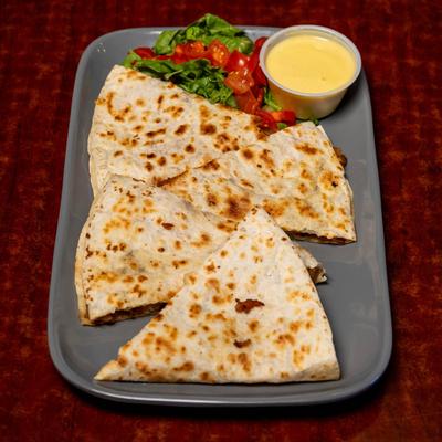 Club Quesadilla with lettuce and tomato garnish and honey mustard.