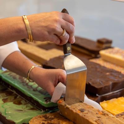 Cutting fresh fudge squares.