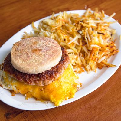 Muffin breakfast sandwich served with hash browns.