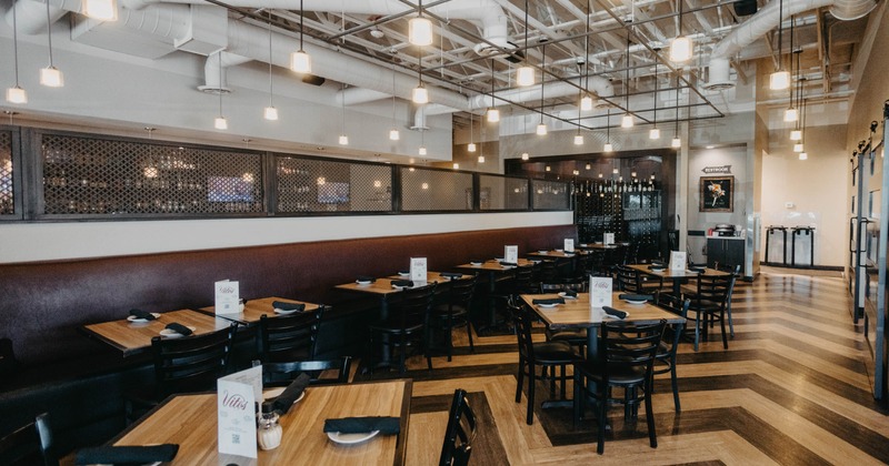 Interior, wooden flooring, tables set for dining, pendant lights