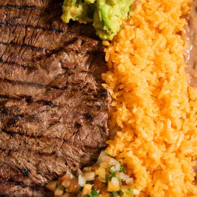 Grilled steak, rice, beans, and salsa.