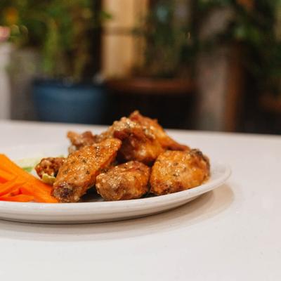 Garlic Parmesan Wings served with celery and carrot sticks