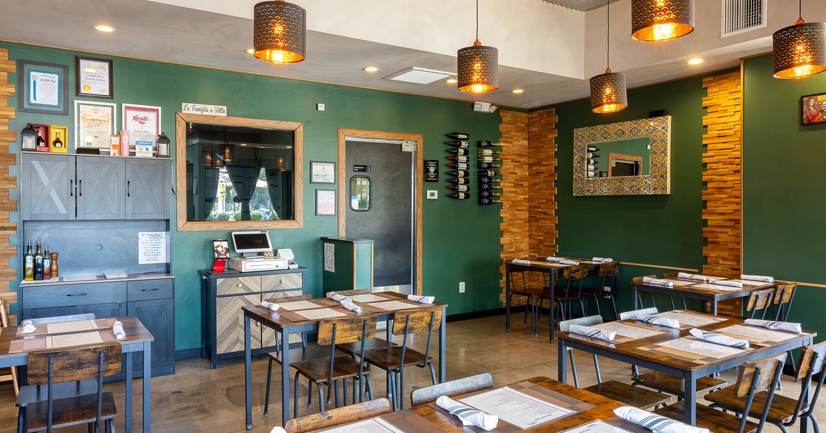 Interior of cozy dining area with dining tables set for guests