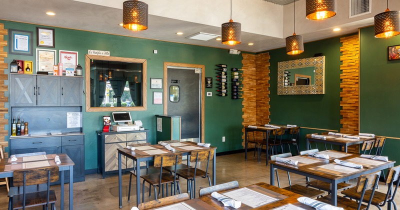 Interior of cozy dining area with dining tables set for guests