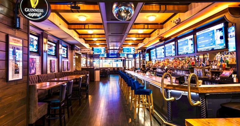Interior featuring booth and bar seating, stocked bar, and a disco ball