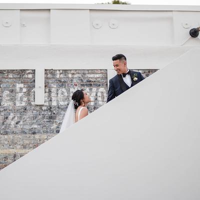 The bride and groom on the stairs.