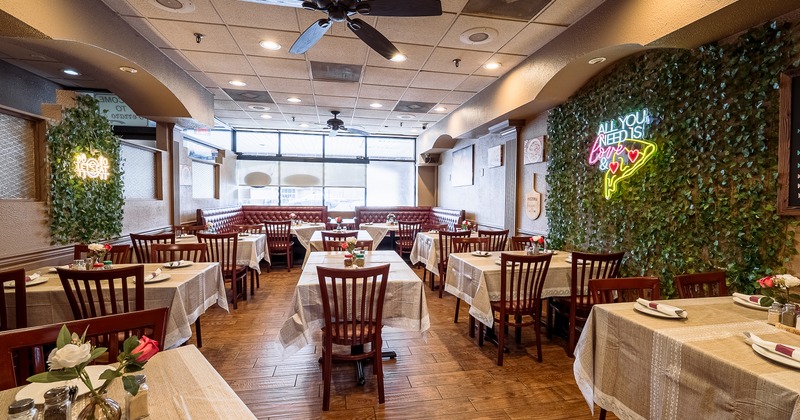 Spacious and cozy restaurant interior dining area with dining tables set for guests