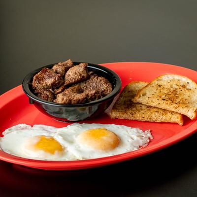 Steak and eggs with toast.