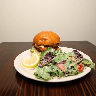 Grilled Chicken Sandwich on brioche bun  with side salad.