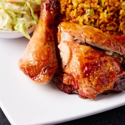 Rotisserie chicken, with vegetarian fried rice and Venezuelan style coleslaw, close up.