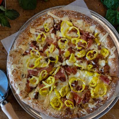 Pizza with extra cheese and sliced vegetables