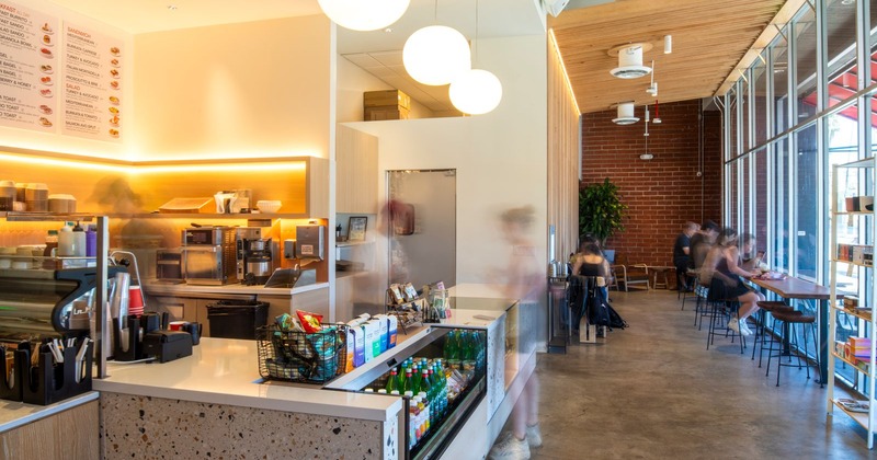 Interior view of a modern cafe with a brightly lit counter
