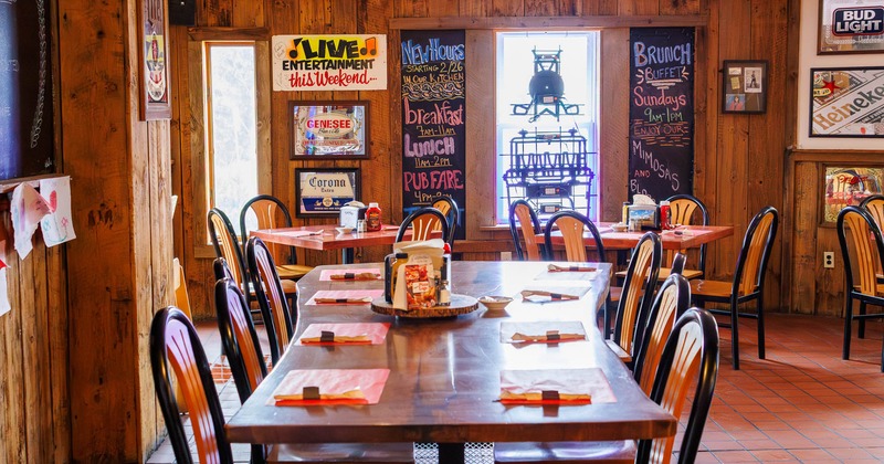 Interior, long dining table with chairs ready for guests