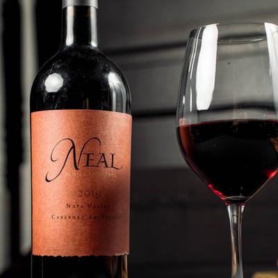 Red wine bottle and filled glass.