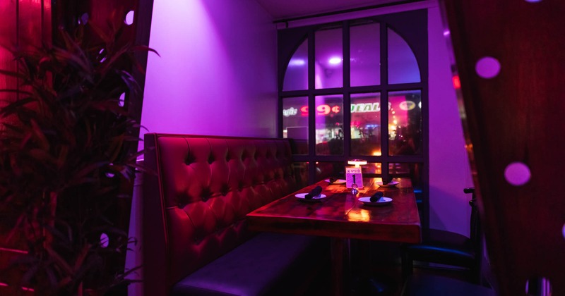 Interior, dining area, seating booth with wooden top table, ready for guests, window