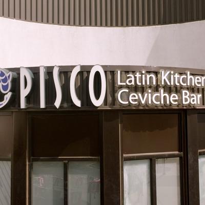 The exterior signage for Pisco Latin Kitchen & Ceviche Bar.
