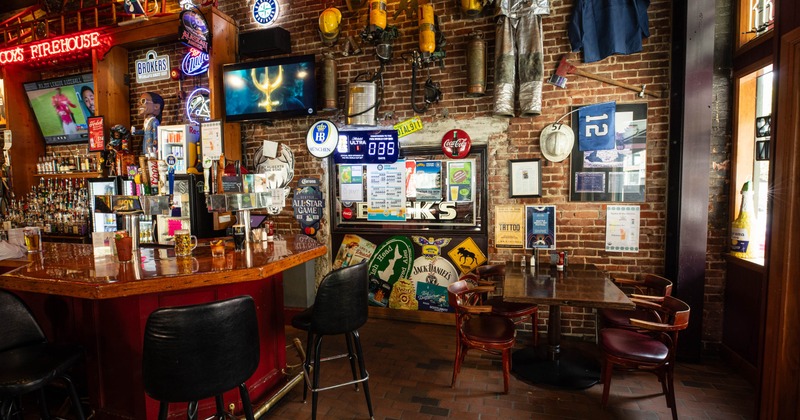Interior, wooden counter bar with stools on the left, table for four on the right