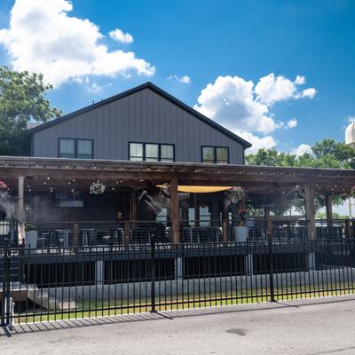 Exterior of Progress Coffee + Beer, with a spacious wooden porch.