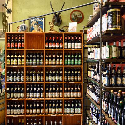 Various beer bottles on shelves.